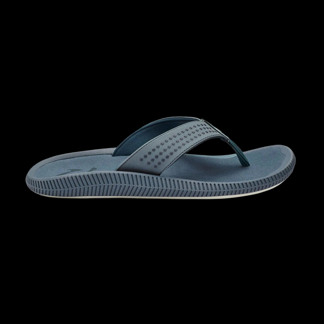 A single dark blue flip-flop sandal with a textured strap and a ribbed sole, shown from a side profile view on a light gray background.